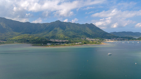 showcasing a tranquil coastline bordered by lush green mountainsの写真素材