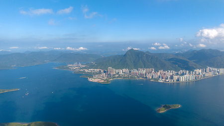 city surrounded by hills and adjacent to serene blue waters under a clear skyの写真素材