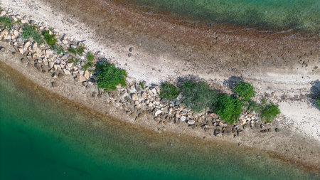 beautiful peninsula surrounded by clear blue watersの写真素材