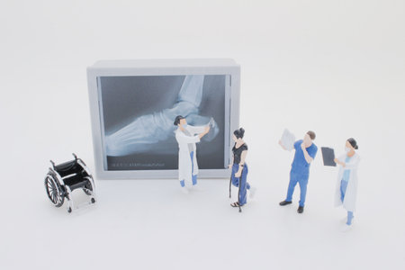 Professionally dressed miniature figures of medical professionals examiningの写真素材