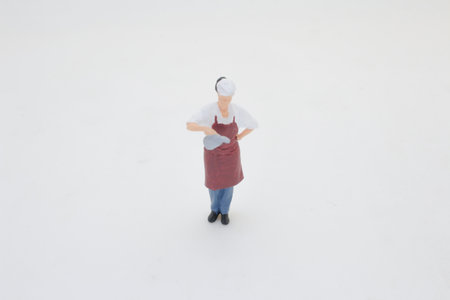 A small-scale figure of a chef dressed in an apron and hat.の写真素材