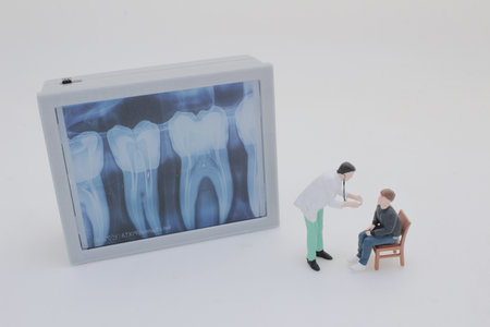 Professionally dressed miniature figures of medical professionals examining