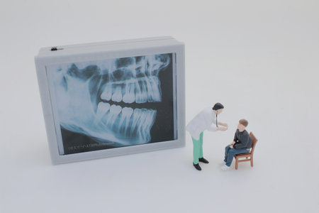 Professionally dressed miniature figures of medical professionals examiningの写真素材