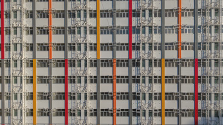 modern high-rise building with a vibrant facade featuring verticalの写真素材