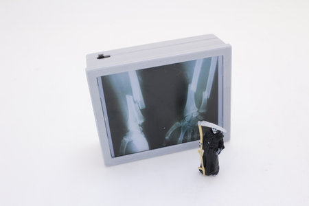 Intriguing composition of a miniature grim reaper figurine examiningの写真素材