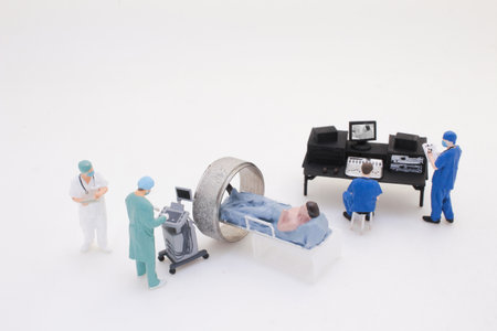 Detailed depiction of a miniature medical team conducting a CT scanの写真素材