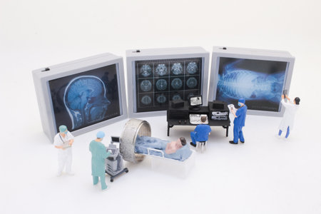 Representations of a small medical team examining x-ray and MRI imagingの写真素材