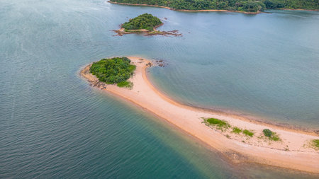 A picturesque coastline featuring lush green islands and a calm blue seaの写真素材