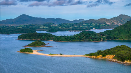 A picturesque coastline featuring lush green islands and a calm blue seaの写真素材