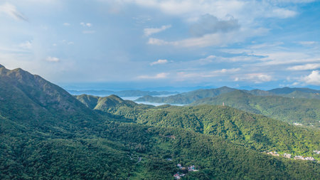 A panoramic shot showcasing verdant hills covering a landscapeの写真素材