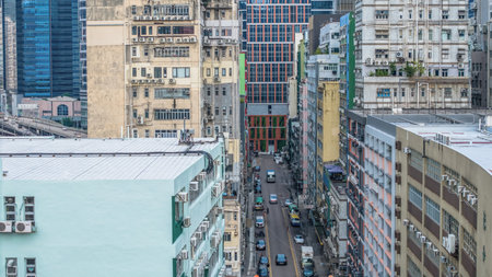 bustling urban street flanked by tall residential and commercial buildingsの写真素材
