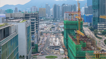 bustling construction site featuring cranes, scaffolding frameworks,の写真素材