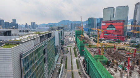 bustling construction site featuring cranes, scaffolding frameworks,の写真素材