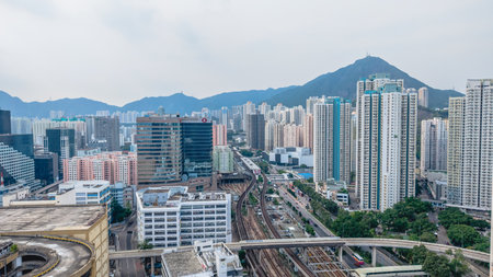 bustling cityscape featuring elevated train tracks traversing through modernの写真素材