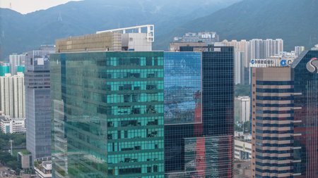 Dynamic city landscape with towering glass skyscrapers and urban skylineの写真素材