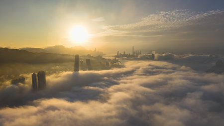 March 2 2025 skyscrapers surrounded by rolling fog with a serene mountain backdrop.