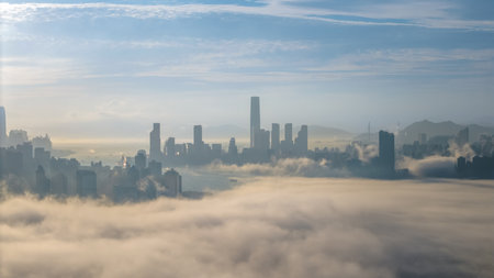 March 2 2025 skyscrapers surrounded by rolling fog with a serene mountain backdrop.