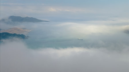 March 2 2025 breathtaking aerial view of a city by the sea, enveloped in fog