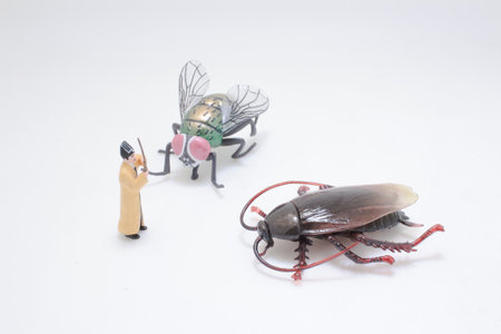 A small toy figurine stands near larger-than-life replicas