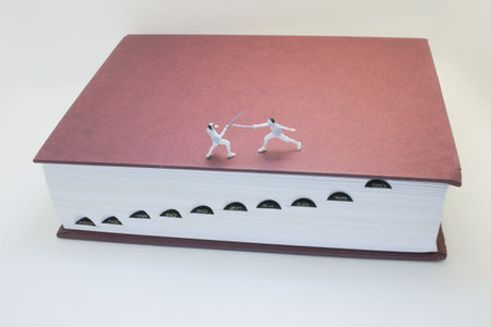 Creative depiction of miniature fencing figures engaging in duel