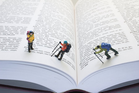 figurines of hikers are depicted traversing the open pages