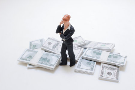 A miniature model of a professional woman standing around bundles
