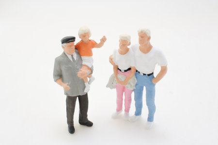 Miniature figurines portray a family scene, showcasing togethernesの写真素材