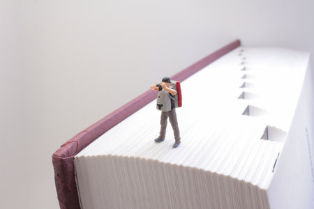 A conceptual image of a tiny figure backpacker standing on the edgeの写真素材