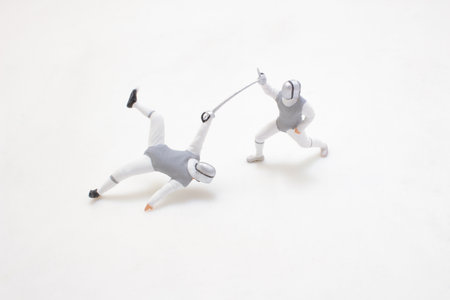 Two fencers compete in a dynamic match, showcasing precise movementsの写真素材
