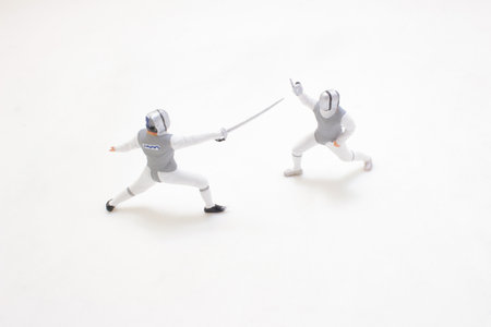 Two fencers compete in a dynamic match, showcasing precise movements
