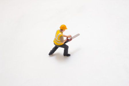 Detailed miniature figurine of a worker in protective gear usingの写真素材