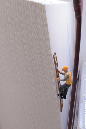 conceptually creative depiction showcasing a miniature construction figureの写真素材