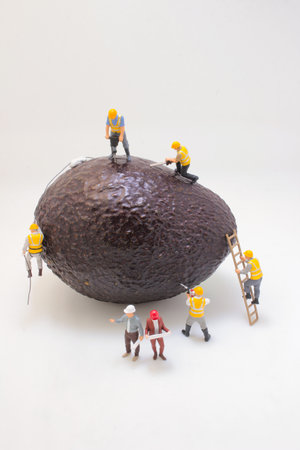 Creative conceptual image showing tiny construction workers operating