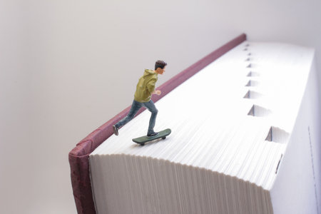 A close-up creative shot depicting a miniature figure skateboardingの写真素材