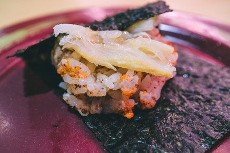 A detailed image of sushi rice garnished with colorful toppings servedの写真素材