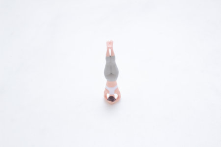 A small figurine in a meditative yoga pose, symbolizing relaxationの写真素材