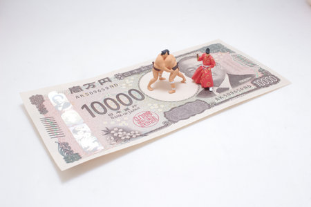 sumo wrestler and traditional figure placed on a Japanese 10,000 yenの写真素材