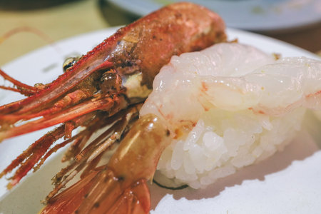Delicious nigiri sushi featuring sweet shrimp adornedの写真素材