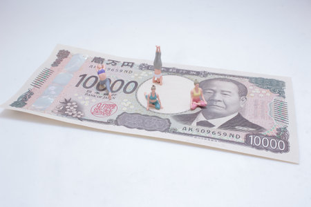 Creative conceptual image showing miniature figurines engaged in yogaの写真素材