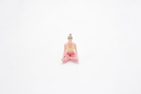 A small figurine in a meditative yoga pose, symbolizing relaxationの写真素材
