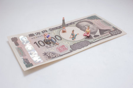 Creative conceptual image showing miniature figurines engaged in yogaの写真素材