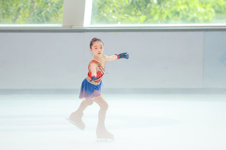 Graceful young girl skating on ice, showcasing a dazzling figureのeditorial素材