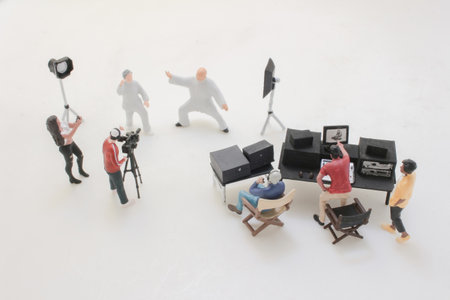 A tiny crew operates a video shoot in a miniature studio,