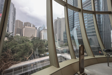 A curved glass atrium frames a dense urban skyline