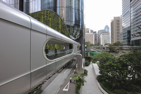 A modern, curved glass skyscraper reflects surrounding downtown