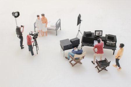 miniature film crew stages a bedroom scene with cameras, lights,