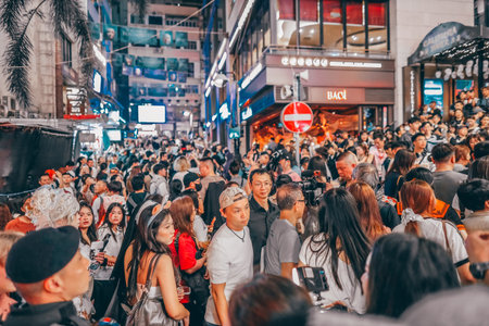 Festive street party with costumes, lights, and nightlifeの写真素材