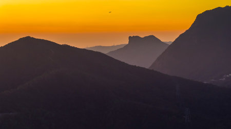 Urban skyline framed by iconic Lion Rock silhouetteの写真素材