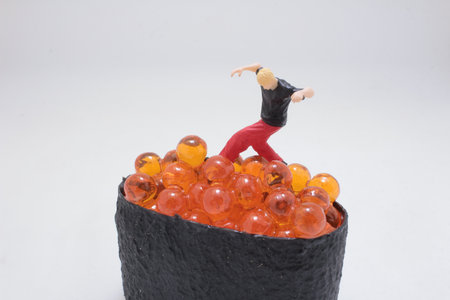 A tiny figurine performs a handstand atop a clusterの写真素材