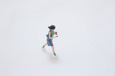 A small figurine of a girl in a blue dress with green socksの写真素材